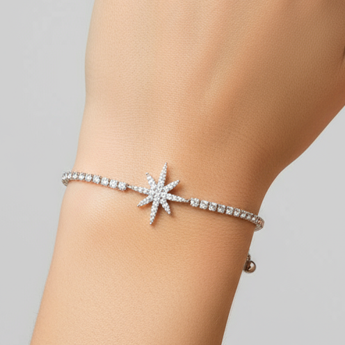 Silver bracelet with star-shaped clasp on a white background