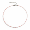 Necklace with pink beads on a white background