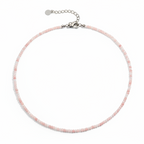 Necklace with pink beads on a white background