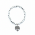Bracelet with heart-shaped charm on a white background
