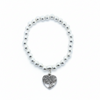 Bracelet with heart-shaped charm on a white background