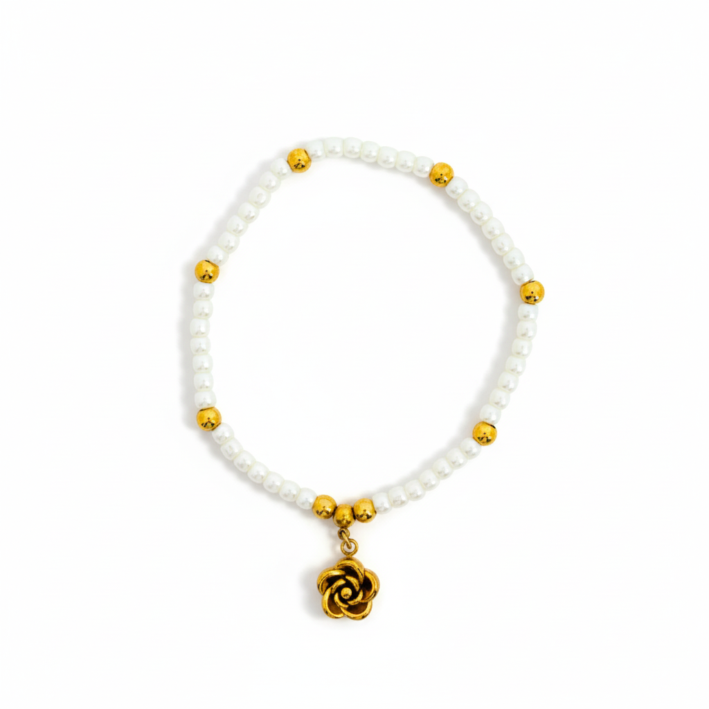 Bracelet with white beads and gold accents on a white background
