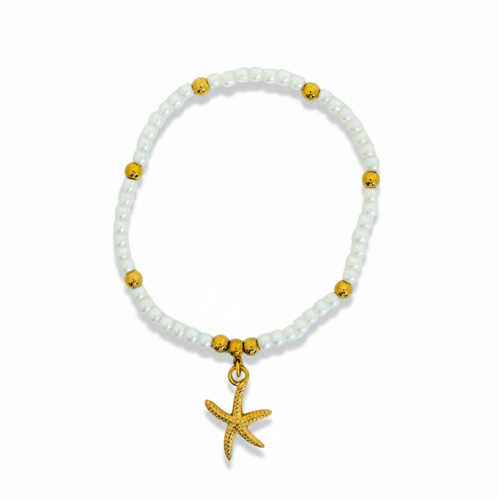 Bracelet with white beads and gold accents on a white background