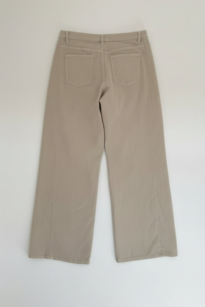 Beige pants on a hanger against a white background
