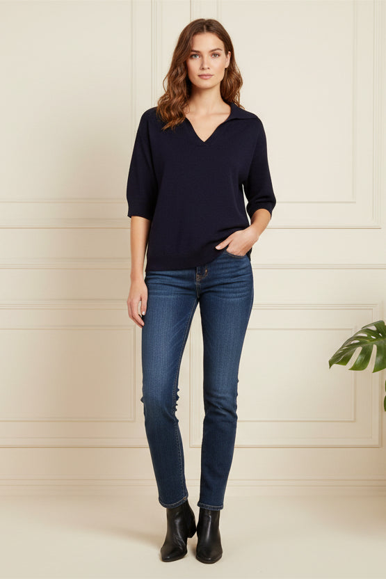 Mannequin wearing a navy blue top and black pants on a gray background