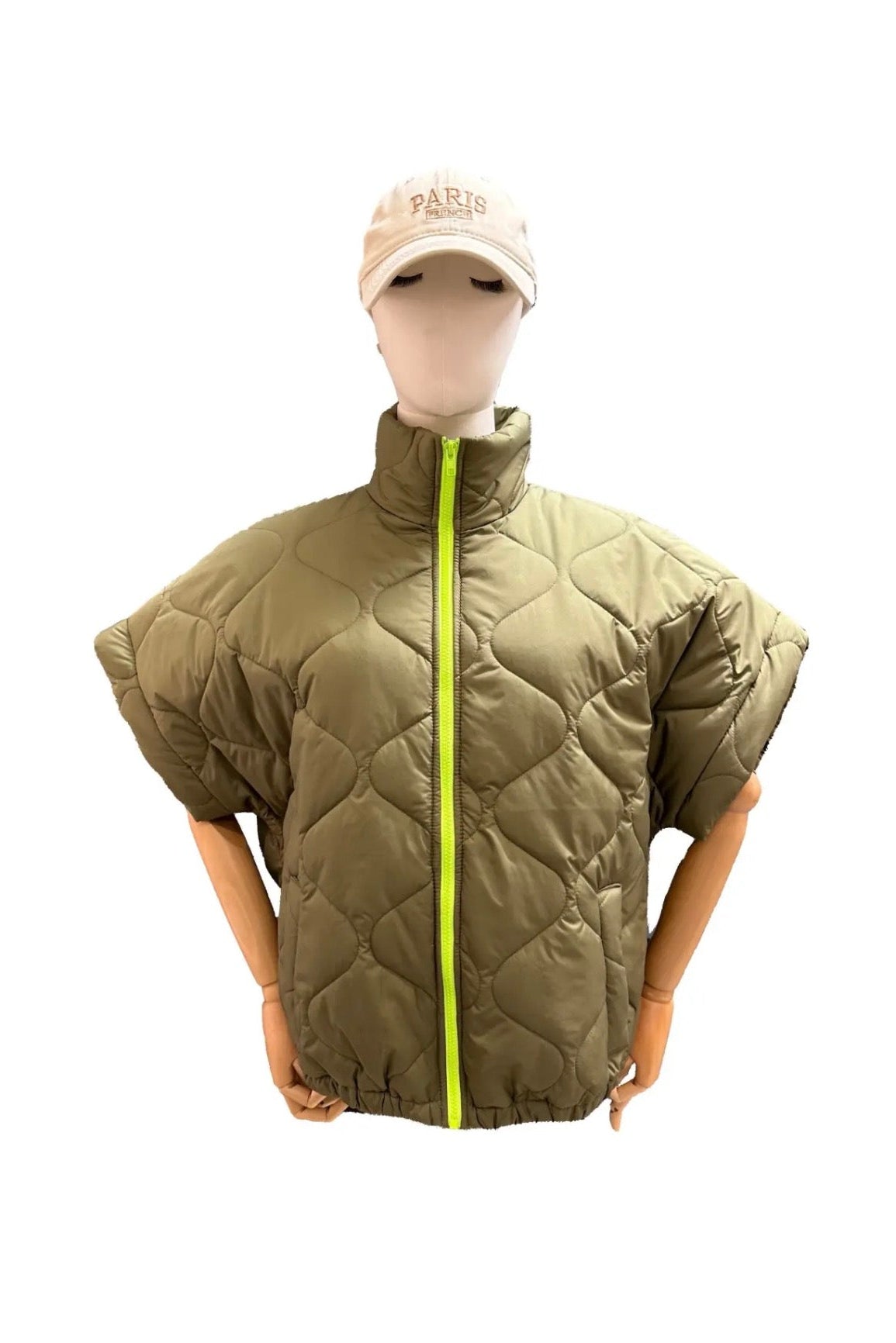 Quilted poncho worn by a mannequin on a white background