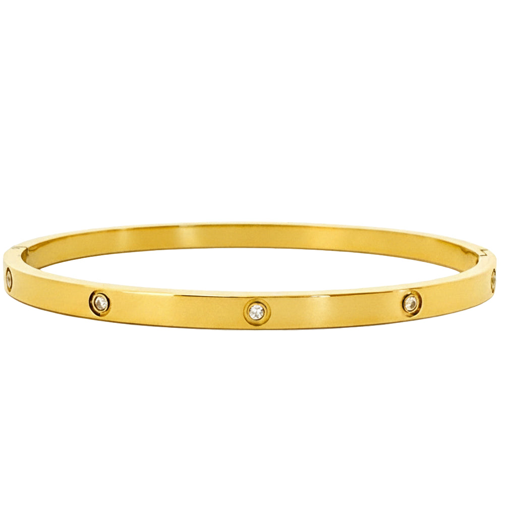Gold bangle with embedded diamonds on a white background