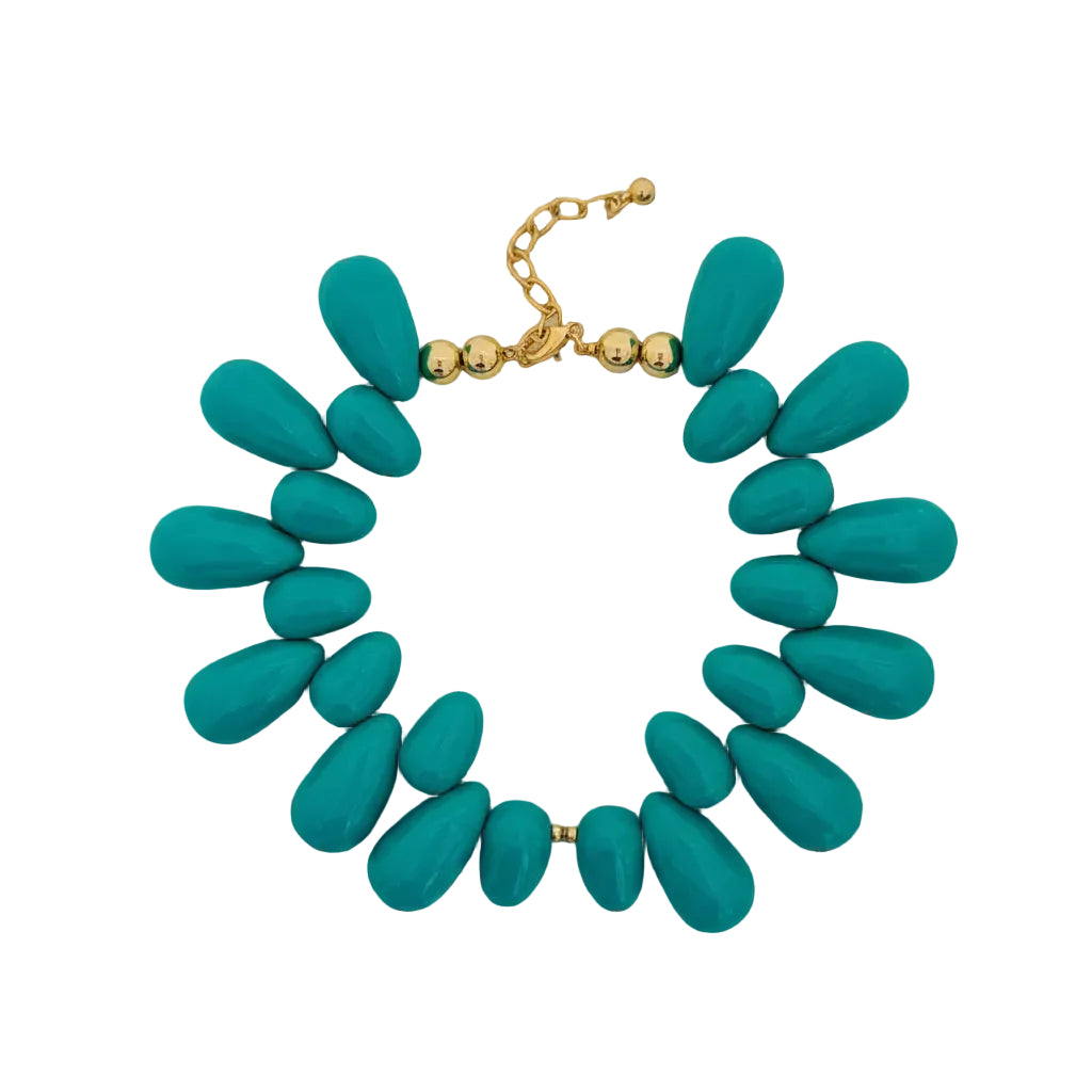 A statement necklace with large, teardrop-shaped turquoise beads and a gold-tone chain clasp, displayed on a white surface.
