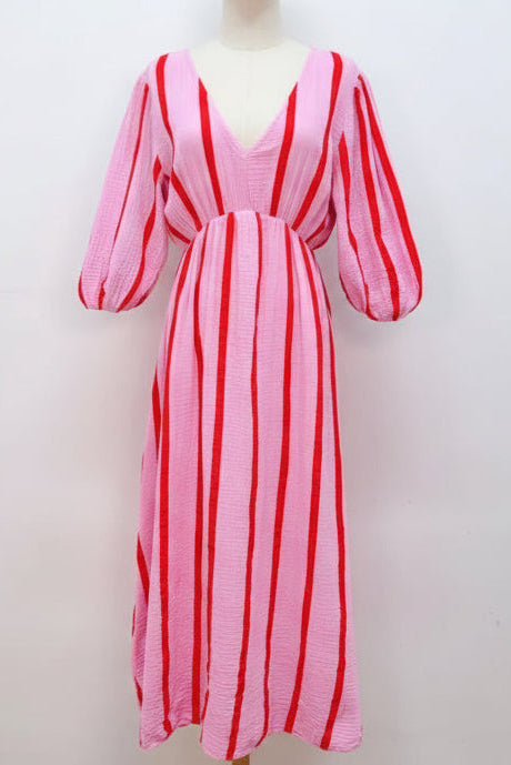 Pink and red striped dress on a mannequin against a white background