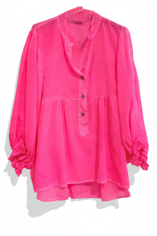Pink blouse with buttons on a pink background