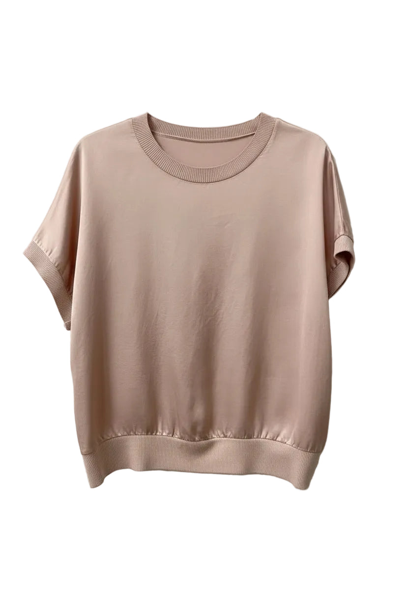 Pink sweater on a hanger against a white background