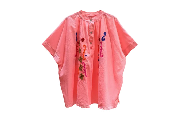 Pink shirt with colorful designs on a white background