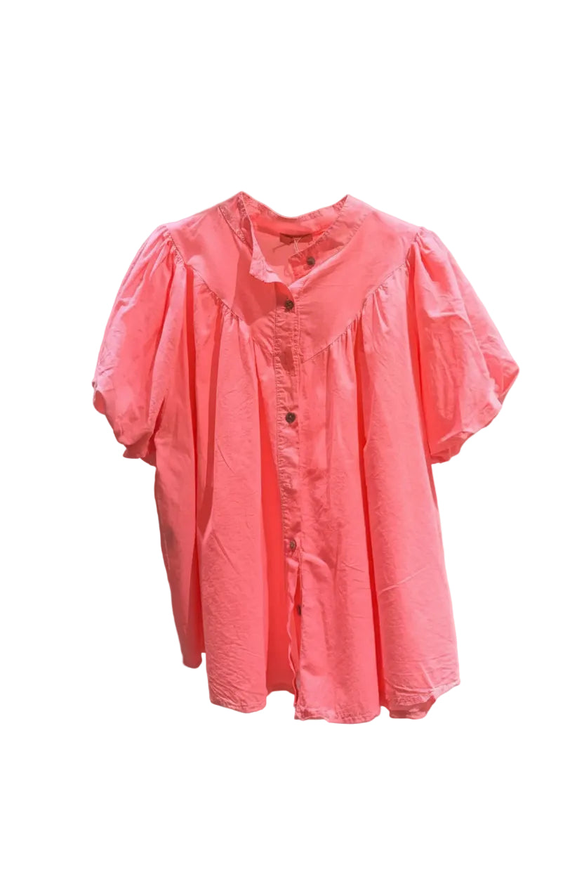 Pink blouse on a hanger against a white background