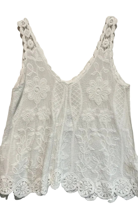 White lace tank top on a wooden hanger against a plain background