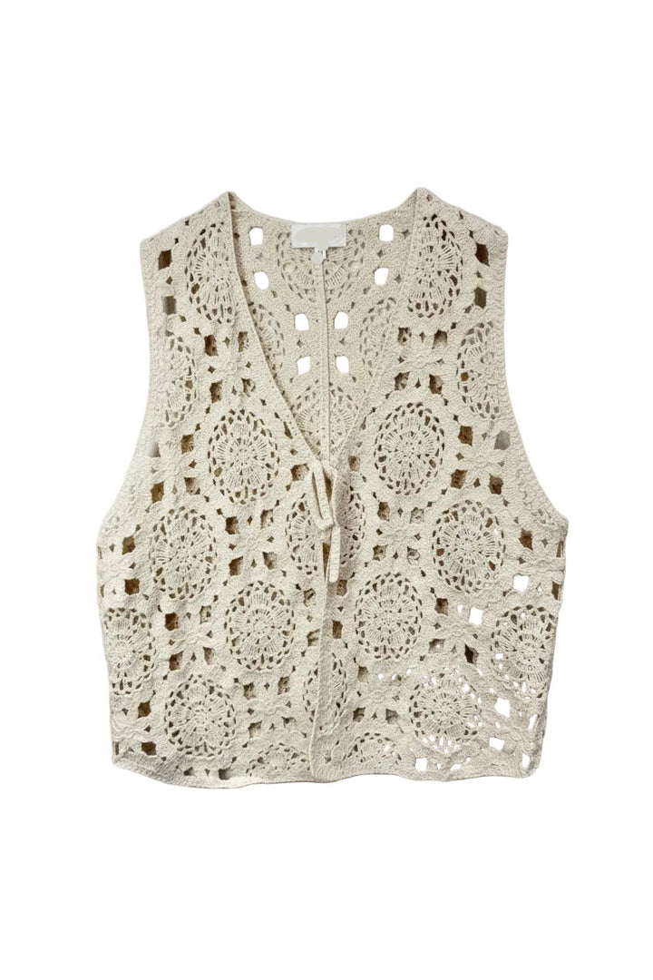Beige crochet vest on a hanger against a light background