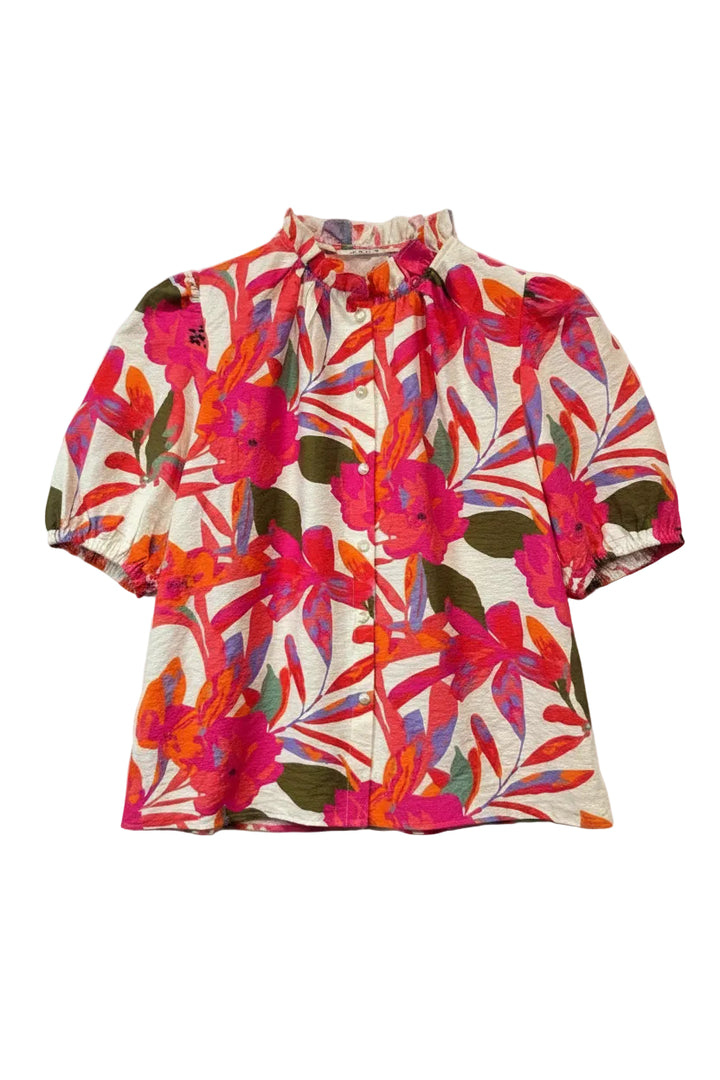 Colorful floral-patterned shirt on a hanger against a plain background