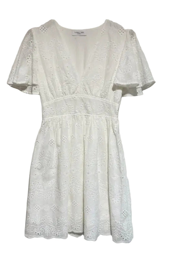 An off-white eyelet lace mini dress with short flutter sleeves and a V-neckline, hanging on a wooden hanger against a textured white wall.