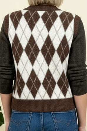 Brown and white argyle patterned sweater vest worn by a person.