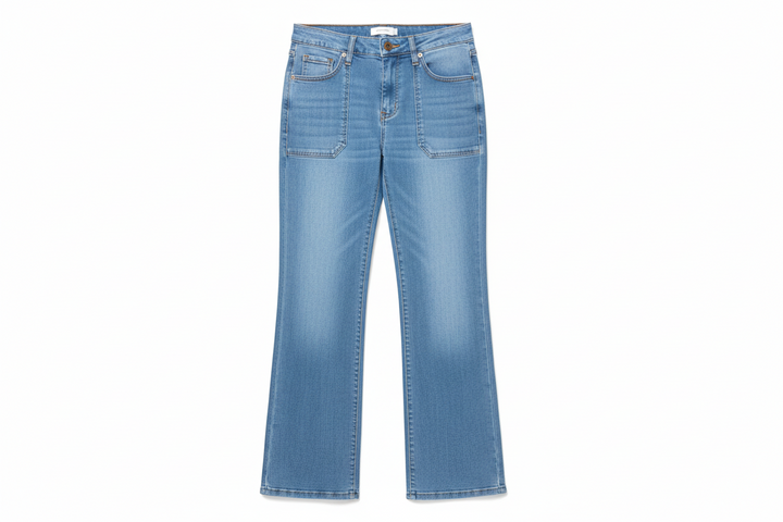 Person wearing blue jeans standing on a grassy area