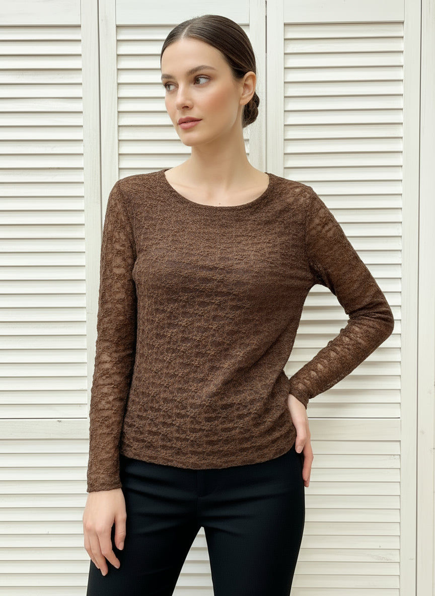 Folded brown textured shirt on a white background