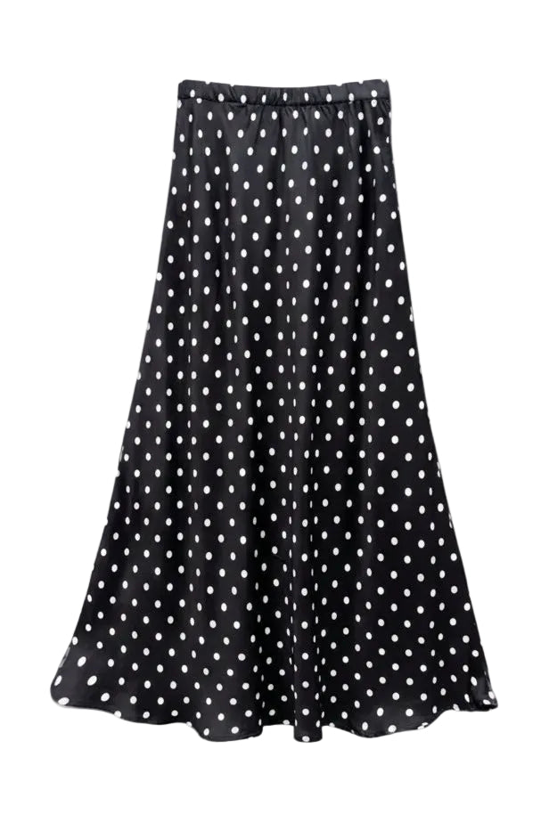 A black midi skirt with a white polka dot pattern, hanging from a light-colored wooden hanger against a light gray background.