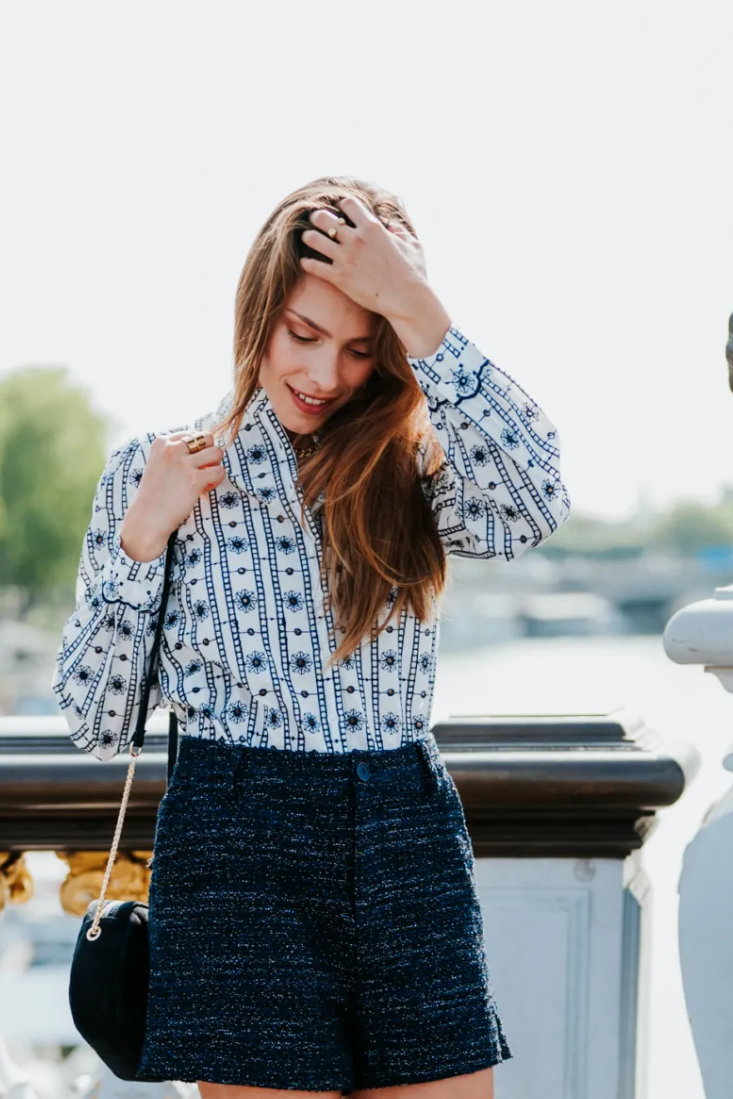 Woman posing on a bridge with a scenic background