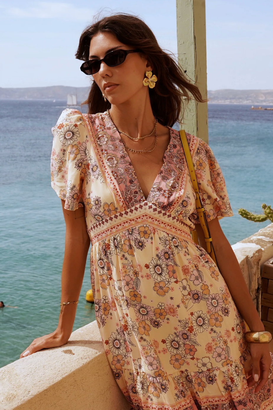 Woman in a floral dress by the sea