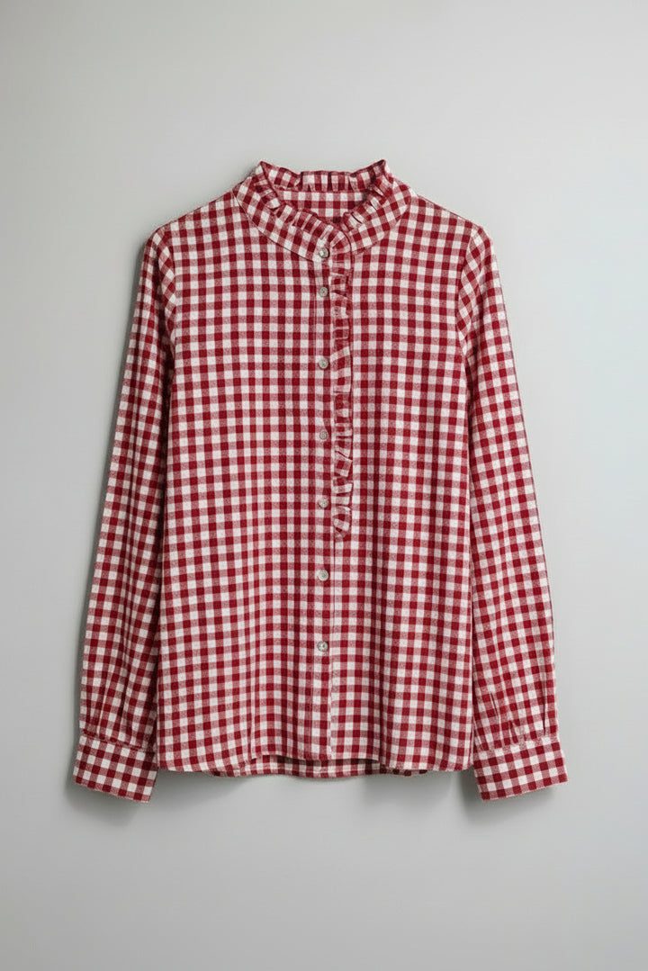 Red and white checkered shirt on a hanger against a gray background