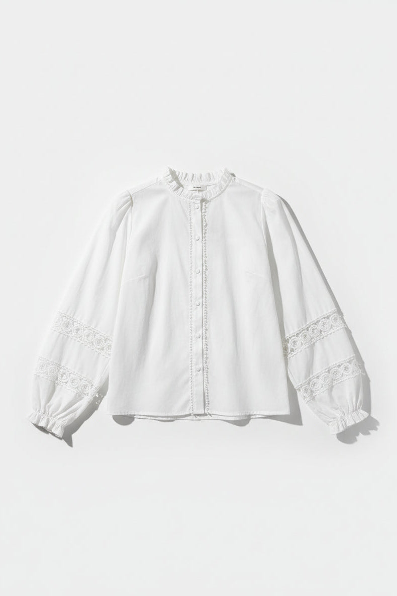 White blouse with lace details on a white background