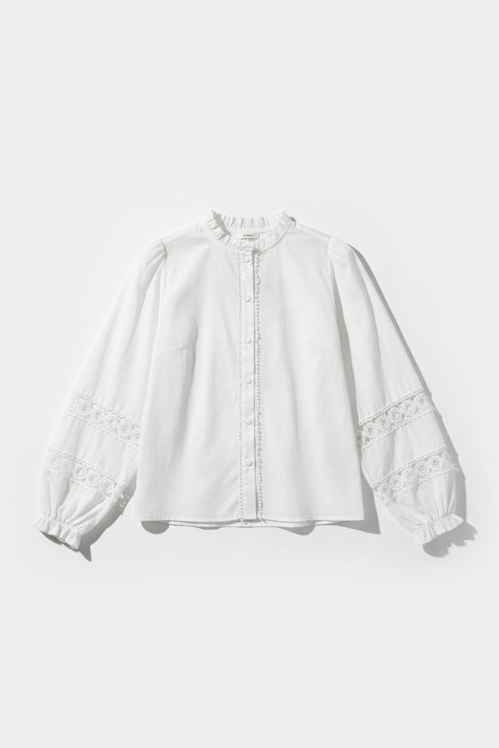 White blouse with lace details on a white background
