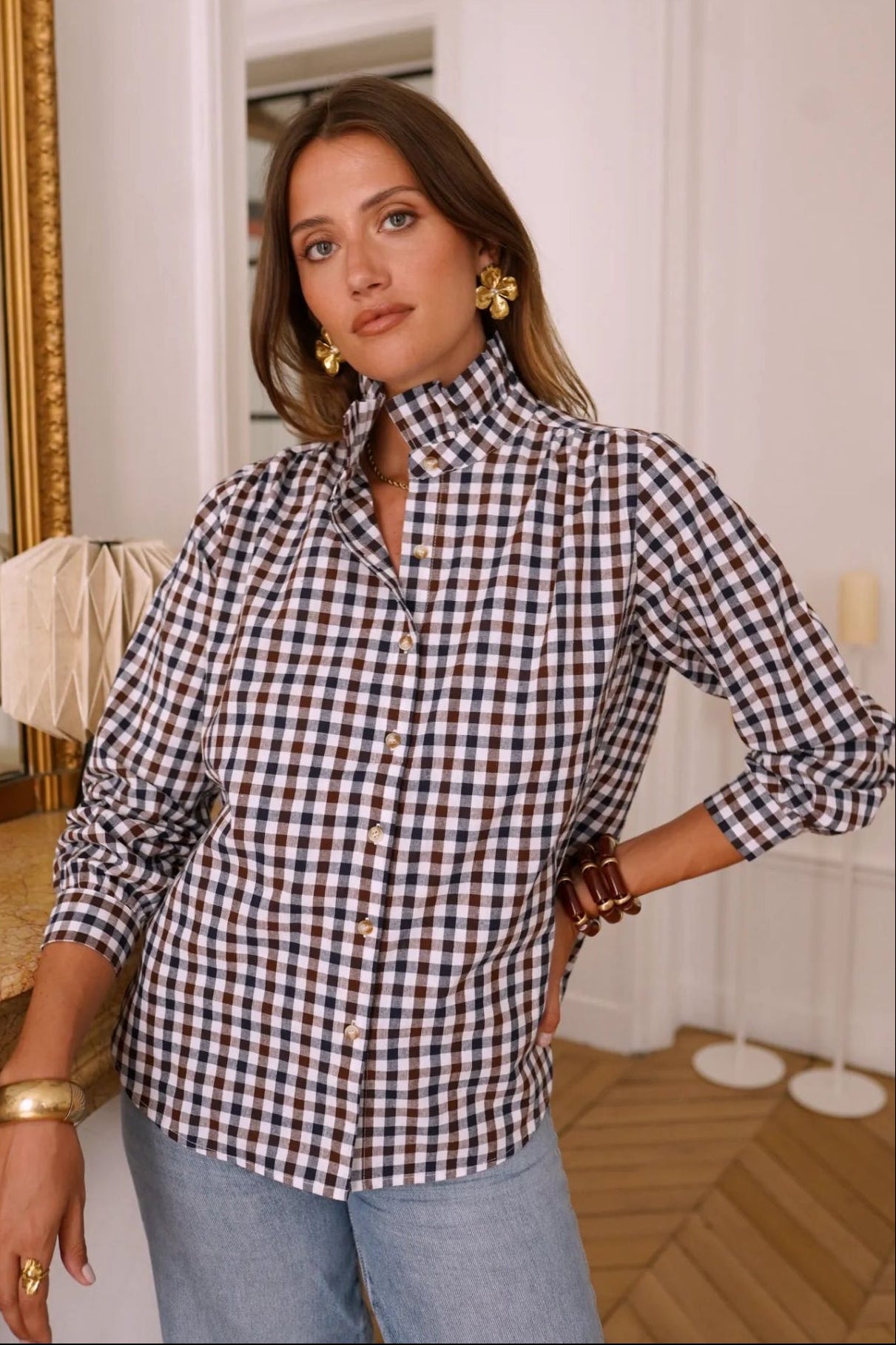 Woman wearing a black and white checkered shirt in an indoor setting
