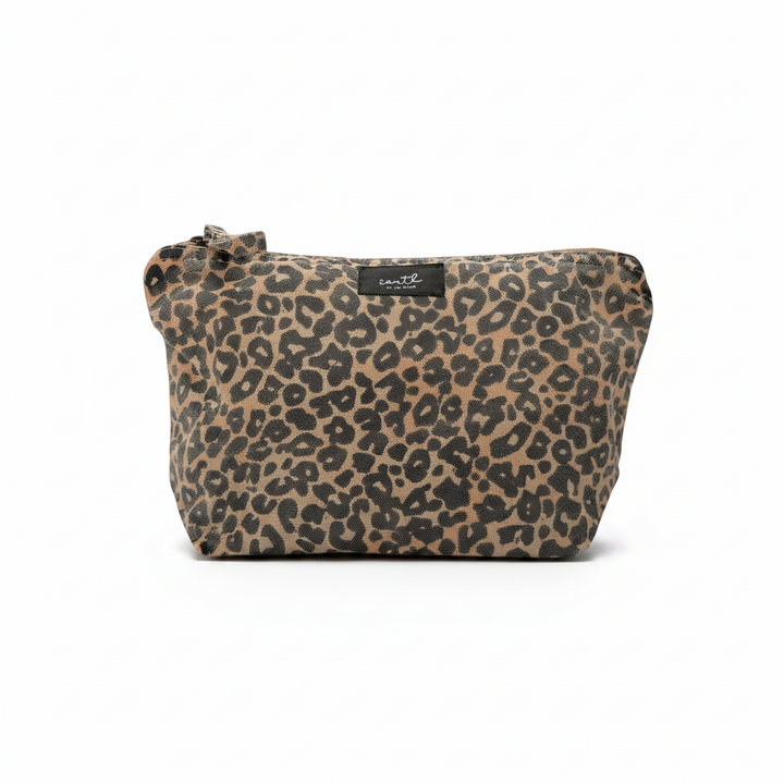 A leopard print cosmetic pouch with a top zipper and a small black brand label, shown against a plain white background.