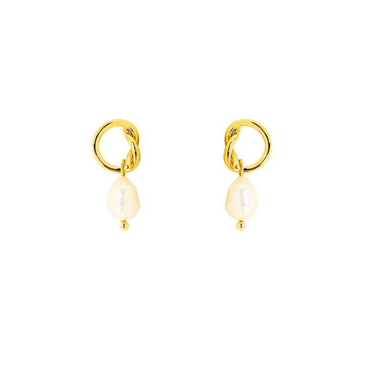Gold earrings with pearl drops on a white background