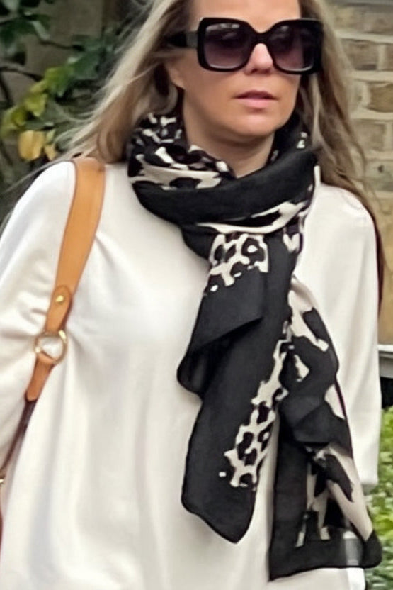 girl wearing black leopard print scarf