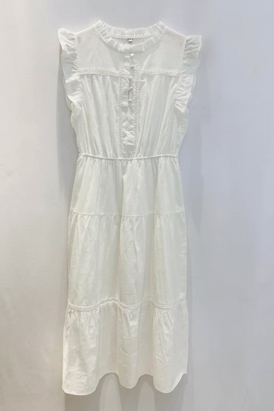 A white sleeveless midi dress with ruffled cap sleeves, a buttoned front placket, and tiered skirt, hanging on a wooden hanger against a plain white wall.