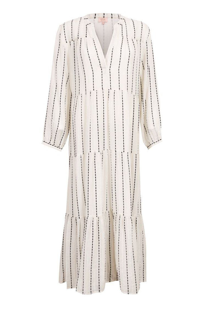 An off-white midi dress with vertical black dotted stripes, featuring a V-neckline, long sleeves, and a tiered ruffle hem.