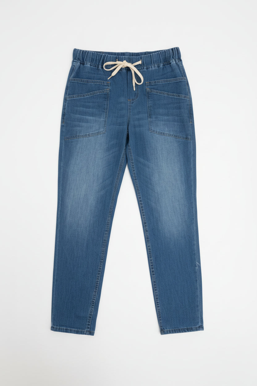 Pair of blue jeans on a hanger against a white wall