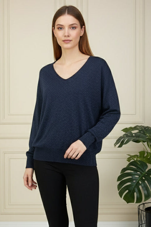 Mannequin wearing a dark blue sweater on a gray background