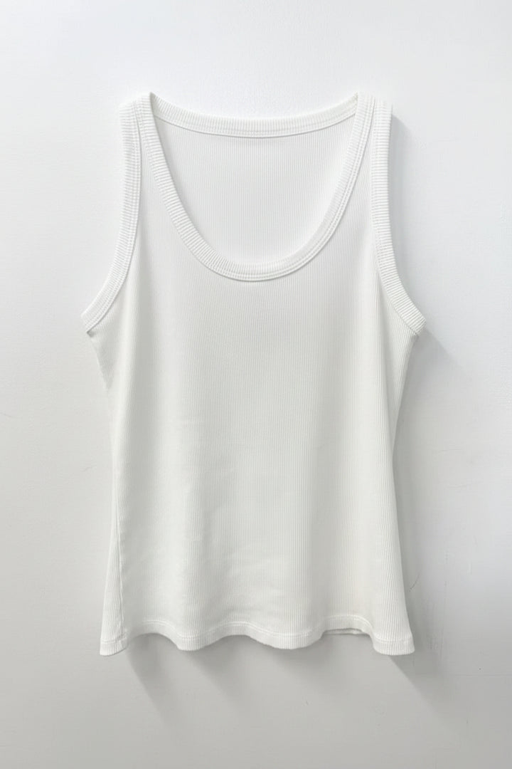White tank top on a wooden hanger against a white background